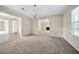 Formal dining room with neutral carpet and a view to the living room at 1870 Rocksram Dr, Buford, GA 30519