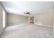 Spacious living room with neutral carpeting and ceiling fan at 1870 Rocksram Dr, Buford, GA 30519