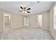 Bright bedroom with neutral carpeting and ceiling fan at 1870 Rocksram Dr, Buford, GA 30519