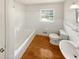 Clean bathroom with white tile, hardwood floors, and bathtub at 741 Prince Ave, Marietta, GA 30062