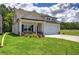 Cream-colored house with a front porch, stone accents, and a two-car garage at 111 Sunflower Ne Cir, Cartersville, GA 30121