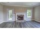 Living room with stone fireplace and wood-look flooring at 111 Sunflower Ne Cir, Cartersville, GA 30121