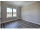Gray vinyl flooring in a bedroom with a large window and white doors at 111 Sunflower Ne Cir, Cartersville, GA 30121