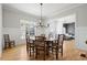 Elegant dining room with a large table, eight chairs, and views to the Gathering room at 6440 Beacon Station Dr, Cumming, GA 30041