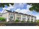 Elegant townhomes, featuring brick exteriors and manicured lawns at 215 Mayfair Ct, Alpharetta, GA 30009
