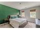 Bedroom with green accent wall, a queen-size bed, and ample closet space at 217 Maple Nw St, Atlanta, GA 30314