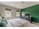 Bedroom with green accent wall, queen bed, and built-in dresser at 217 Maple Nw St, Atlanta, GA 30314