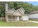 Tan two-story house with a garage and porch at 217 Maple Nw St, Atlanta, GA 30314