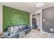 Living room features a black leather sofa and artificial greenery wall at 217 Maple Nw St, Atlanta, GA 30314