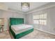 Spacious bedroom with a large green upholstered bed and neutral carpeting at 217 Maple Nw St, Atlanta, GA 30314