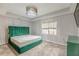 Main bedroom with plush green velvet bed frame and carpet flooring at 217 Maple Nw St, Atlanta, GA 30314