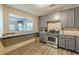 Open concept kitchen with gray cabinets, granite countertops, and breakfast bar at 217 Maple Nw St, Atlanta, GA 30314