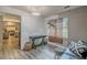 Living room features a black leather sofa and an accent wall with greenery at 217 Maple Nw St, Atlanta, GA 30314