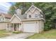 Tan two-story house with a garage and porch at 217 Maple Nw St, Atlanta, GA 30314