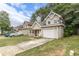 Tan two-story house with attached garage, front yard, and driveway at 217 Maple Nw St, Atlanta, GA 30314