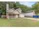 Tan two-story house with a garage and porch at 217 Maple Nw St, Atlanta, GA 30314