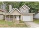 Tan two-story house with attached garage and porch at 217 Maple Nw St, Atlanta, GA 30314