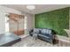 Living room with black leather sofa and an accent wall at 217 Maple Nw St, Atlanta, GA 30314