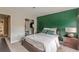 Bedroom with green accent wall, a queen-size bed, and a walk-in closet at 217 Maple Nw St, Atlanta, GA 30314