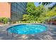 Community pool with patio furniture and nearby building at 3060 Pharr Court North Nw # 317, Atlanta, GA 30305