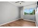 Bedroom with wood-look floors, ceiling fan, and large window at 3060 Pharr Court North Nw # 317, Atlanta, GA 30305