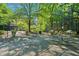 Community patio with tables, chairs, and grills under shade trees at 3060 Pharr Court North Nw # 317, Atlanta, GA 30305