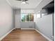 Bedroom with wood-look floors, large window with city view, and neutral walls at 3060 Pharr Court North Nw # 317, Atlanta, GA 30305