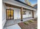 Modern farmhouse style front entrance with black framed glass door at 321 Roper Rd, Canton, GA 30115