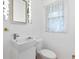 Small bathroom with a pedestal sink and toilet at 2478 Woodacres Ne Rd, Atlanta, GA 30345