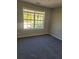 Bedroom with large window and neutral decor at 15 Lumby Ln, Covington, GA 30016