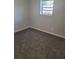 Spacious bedroom with grey carpet and window at 15 Lumby Ln, Covington, GA 30016