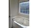 Bathroom with garden tub and window at 15 Lumby Ln, Covington, GA 30016