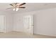 Spacious bedroom with ceiling fan and access to other rooms at 8590 Seabiscuit Rd, Lithonia, GA 30058