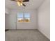 Charming bedroom with neutral carpeting and a large window at 8588 Preakness Pass, Lithonia, GA 30058