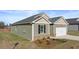 One-story house with a two-car garage and landscaping at 8588 Preakness Pass, Lithonia, GA 30058
