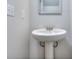Small bathroom with pedestal sink and framed mirror at 6198 Ripple Way # 87, South Fulton, GA 30349