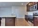 Open kitchen with island, granite countertops, and stainless steel appliances at 6198 Ripple Way # 87, South Fulton, GA 30349