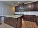 Modern kitchen with granite island and dark cabinets at 6198 Ripple Way # 87, South Fulton, GA 30349