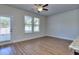 Living room with hardwood floors, ceiling fan, and patio access at 6198 Ripple Way # 87, South Fulton, GA 30349