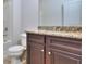 Bathroom with granite countertop, dark brown vanity, and a toilet at 6198 Ripple Way # 87, South Fulton, GA 30349