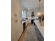 Well-equipped kitchen with white cabinets, a farmhouse sink, and a black range hood at 727 Cascade Sw Ave, Atlanta, GA 30310