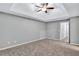 Spacious bedroom with carpeted floor and ceiling fan at 735 Kilkenny Cir, Lithonia, GA 30058