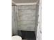 Basement bathroom with a walk-in shower and gray tile at 221 Larkshyre Trl, Lawrenceville, GA 30043