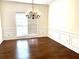 Formal dining room with hardwood floors and chandelier at 221 Larkshyre Trl, Lawrenceville, GA 30043