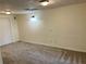 Finished basement room with neutral walls and carpet flooring at 221 Larkshyre Trl, Lawrenceville, GA 30043