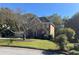 Two-story brick home with a tree and lawn at 221 Larkshyre Trl, Lawrenceville, GA 30043