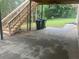 Concrete patio with wooden stairs leading to a yard at 221 Larkshyre Trl, Lawrenceville, GA 30043