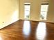 Bright living room featuring hardwood floors and large windows at 221 Larkshyre Trl, Lawrenceville, GA 30043