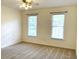 Bright bedroom with neutral walls and carpet, featuring two large windows at 221 Larkshyre Trl, Lawrenceville, GA 30043
