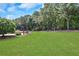 Pergola and expansive lawn with wooded backdrop at 2145 Jones Phillips Rd, Dacula, GA 30019